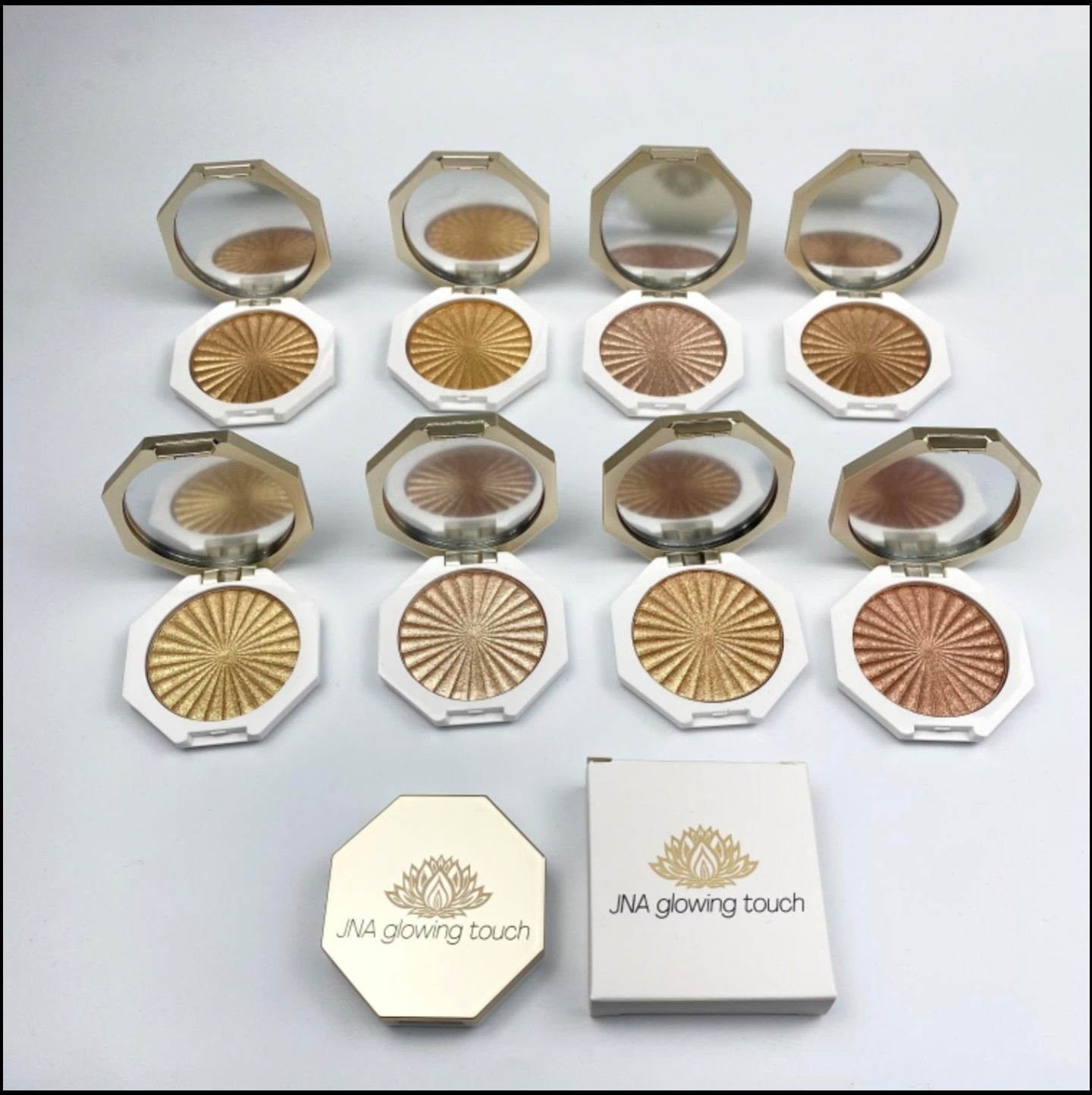 JNA glowing touch highlighter in gold and bronze compact form.