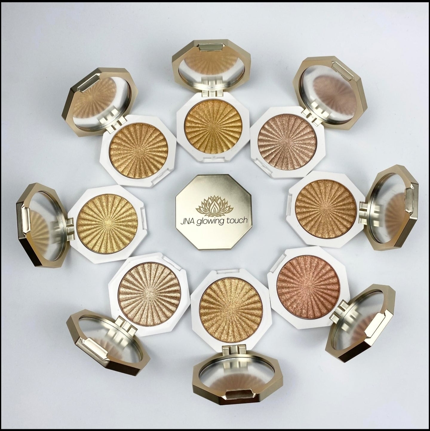 JNA glowing touch highlighter in gold and bronze compact form.
