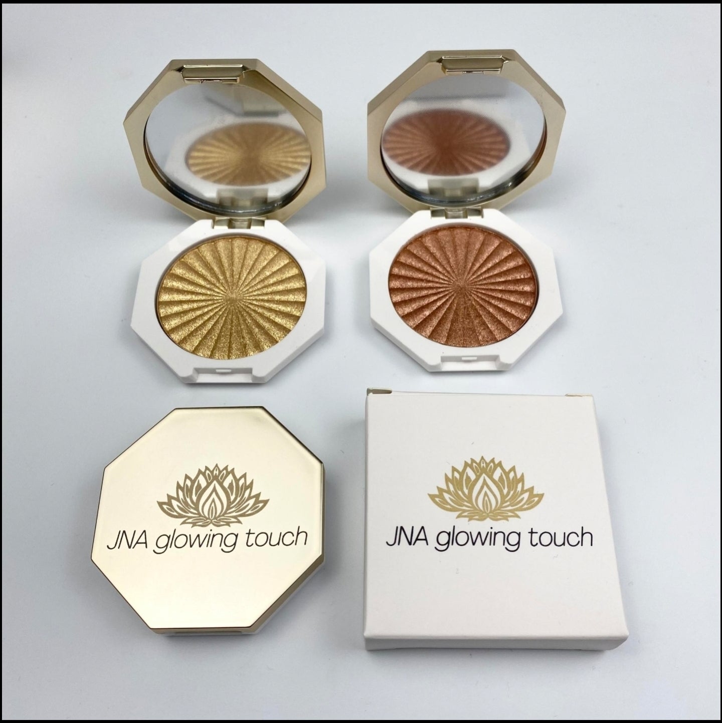 JNA glowing touch highlighter in gold and bronze compact form.